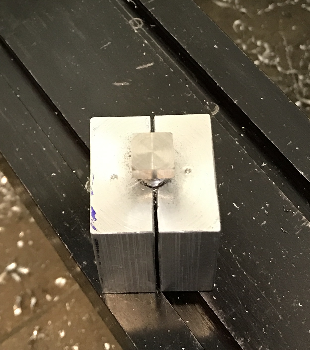 The jig holding the first screw cut to a square